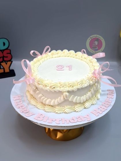 An elegant vintage cake with delicate piping and soft pink ribbons.