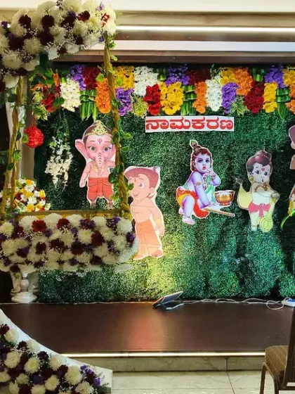 For a fun twist on a traditional naming ceremony, I can add cartoon characters like Chhota Bheem to the backdrop. This setup still includes the popular floral crescent moon swing.