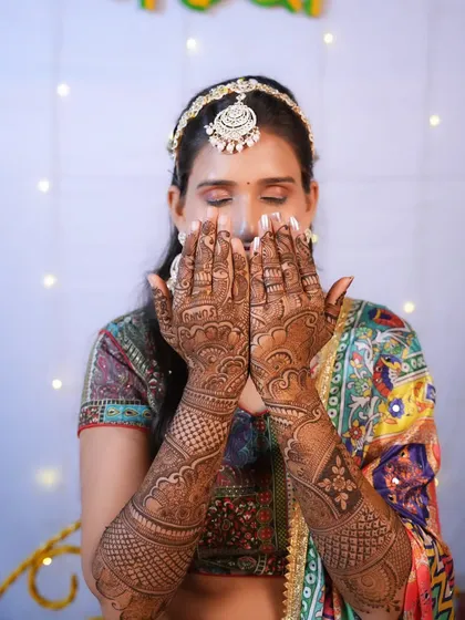 The beauty of Mehendi. This bride shows off her intricate henna design, with her makeup kept soft and subtle to let the artistry shine.