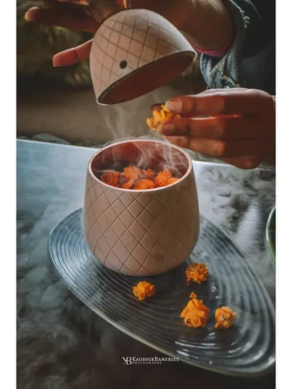 A theatrical presentation of frozen popcorn with liquid nitrogen smoke. This shot captures a unique dining experience, perfect for restaurants that want to highlight their molecular gastronomy dishes.