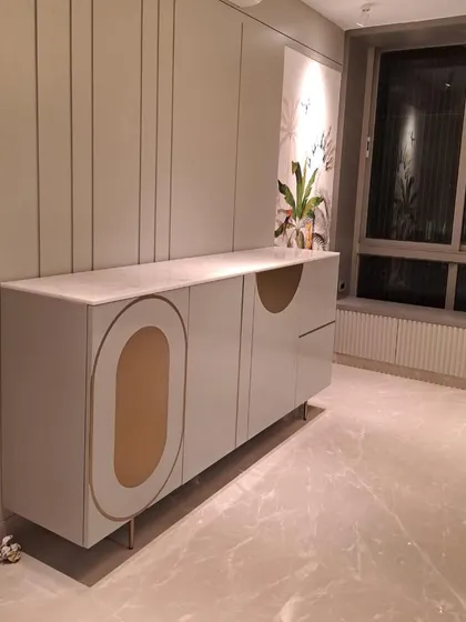 Another angle of the stylish console, highlighting its clean lines and the beautiful contrast between the soft grey finish and the warm brass details.