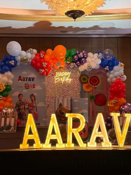 A full view of the stage setup, including the large marquee letters spelling "AARAV" which provide a fantastic photo opportunity.