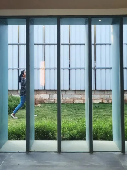 Looking out from within the gallery, the architecture frames the landscape like a painting. This intentional view blurs the boundary between inside and out, creating a moment of quiet reflection and connection to the green space beyond.