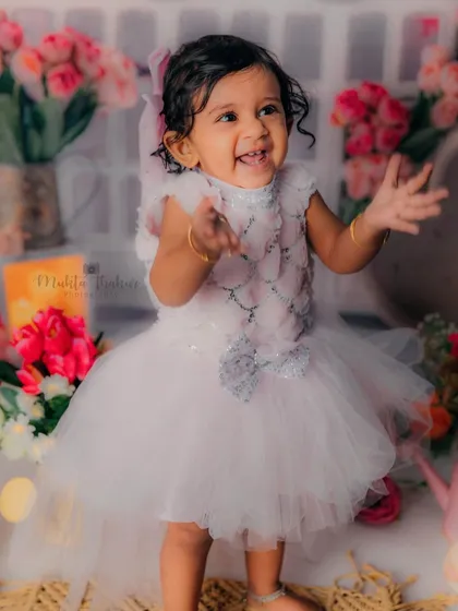Her cuteness can melt your heart. This little girl's joyful expression and happy clap say it all.