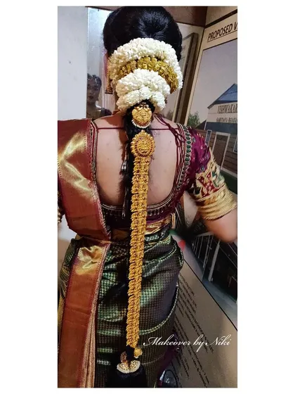 It's all in the details. This is a traditional South Indian bridal hairstyle for Pooja's muhurtham, complete with fresh jasmine flowers and an intricate gold *jadanagam*. I love creating these elaborate and culturally rich hairstyles.