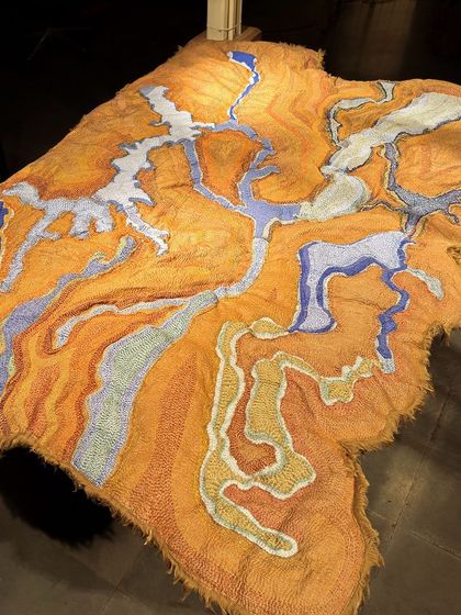 An abstract textile landscape from 'Cu+Fibers', rich in color and texture. This piece is an example of our improvisational approach, where the material guides the final form.