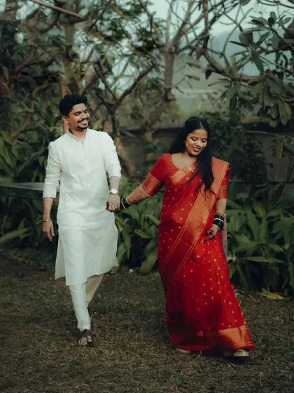 A lovely walking shot of Abhishek and Neelam in a garden. Dressed in traditional wedding attire, they hold hands, symbolizing the start of their journey together.