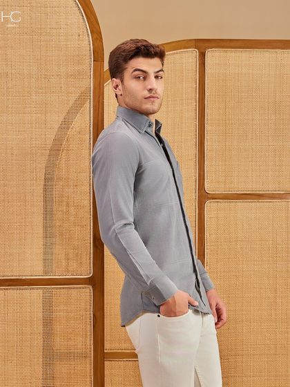 A side profile of the grey corduroy shirt, highlighting its slim, tailored fit and the soft texture that makes it a comfortable yet chic choice for casual wear.