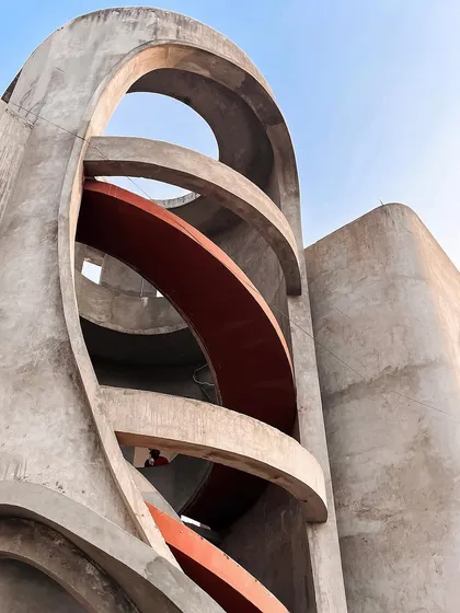 Another view of the sculptural spiral staircase, a central element in the home's dance of fluidity.