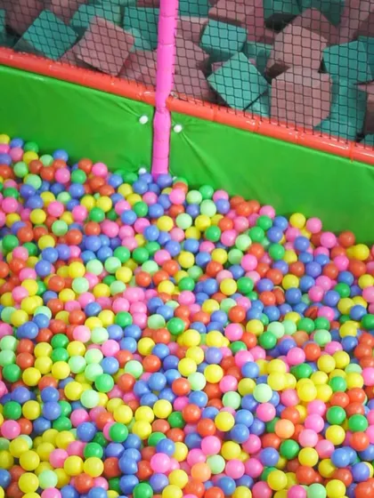 A close-up of our ball pit, filled with thousands of bright, clean, and colorful balls.