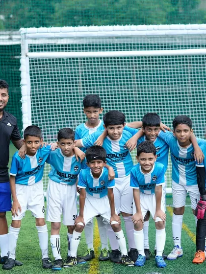 A coach with his arm around his U-11 team. We are more than just a team, we are a family.