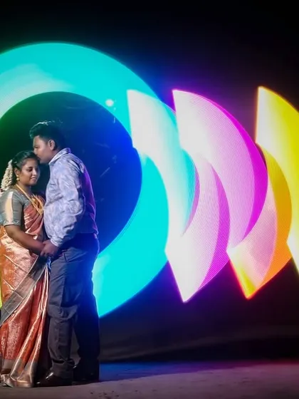I create magic with light. This is a special technique called light painting, where I use long exposure photography to draw vibrant colors in the air around you, creating a one-of-a-kind portrait for this couple.
