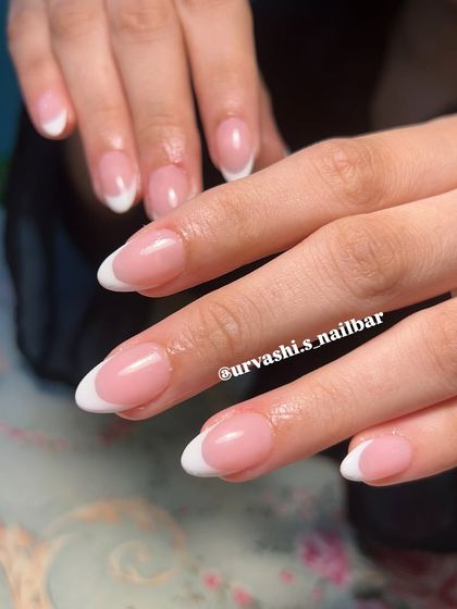 The quintessential classic. This is a perfect, clean French manicure with a natural pink base and crisp white tips on a beautiful almond shape. It's a look that never goes out of style.