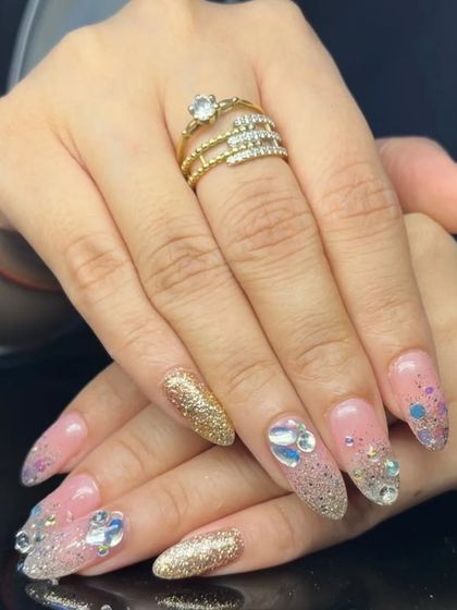 Another angle of the dazzling gold glitter and multi-sized rhinestone manicure.