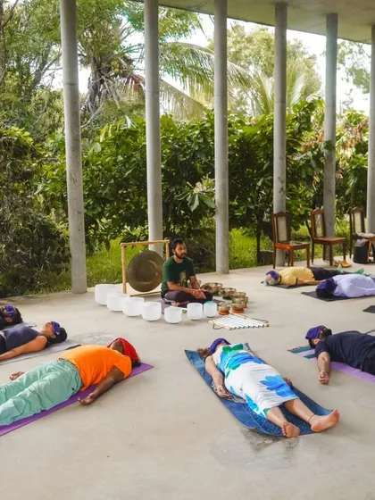 Wellness extends beyond the office walls. Here, a group finds serenity in a nature-infused sound bath, demonstrating how these sessions can be adapted for corporate retreats and off-sites to deepen the restorative experience.