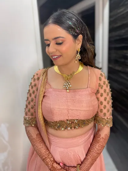A full view of the glitter hair look. Paired with a soft pink outfit, the sparkling hair becomes a statement accessory, perfect for a client who loves to shine.