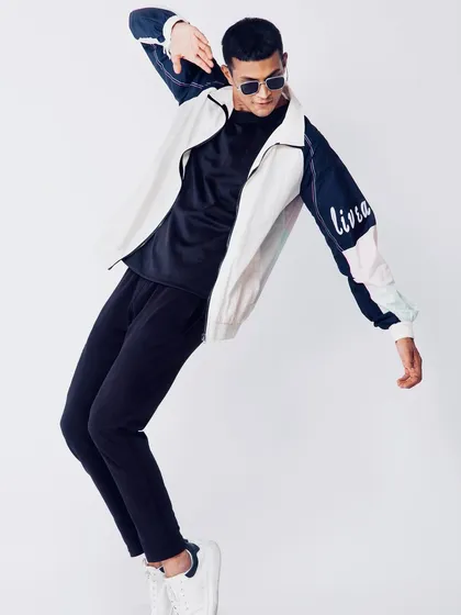 A dynamic action shot of a male model in athleisure wear. Capturing movement is key for activewear brands to show the functionality and fit of their clothing.