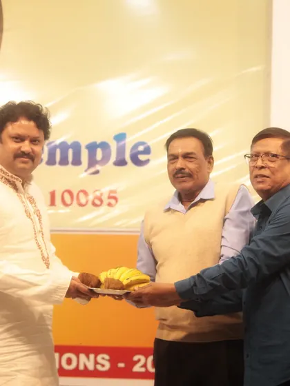 A moment of felicitation after the 'Swarveni Aradhana' event, where I am honored by the temple organizers.