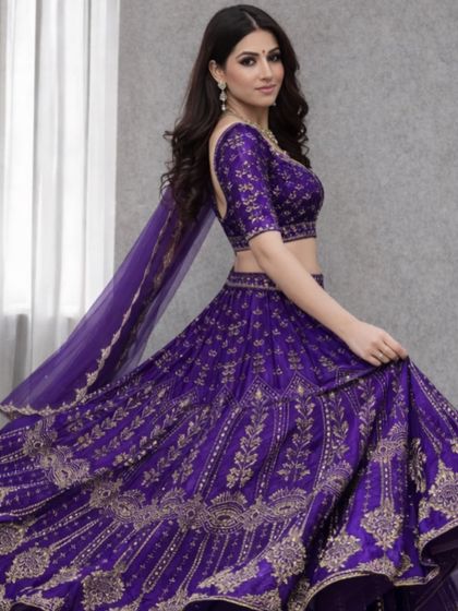 The movement in this shot highlights the beautiful flare of the purple lehenga skirt and the shimmer of the gold embroidery.