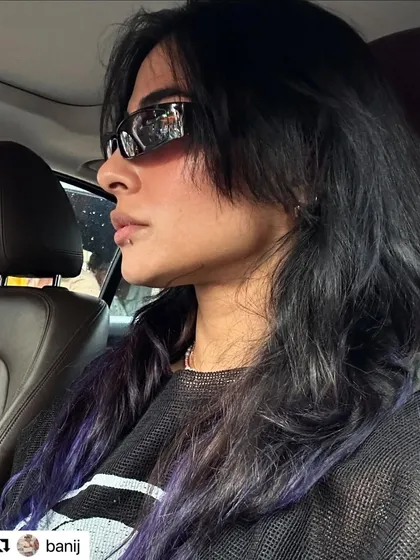Another photo from Bani J, showing her shag haircut after the color had transitioned to a cool purple hue.