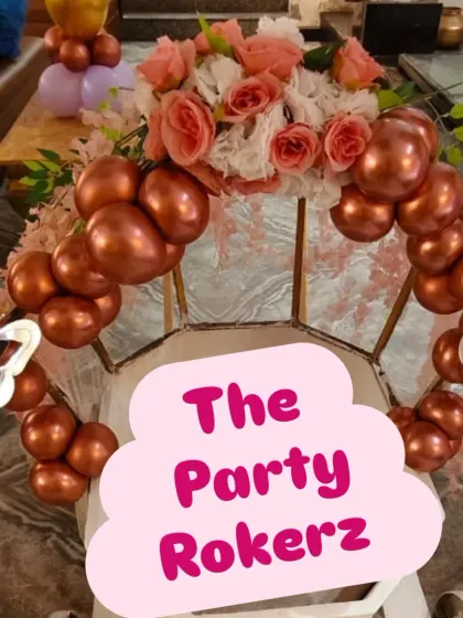 A beautiful floral and balloon arrangement for a butterfly-themed cake table. The mix of fresh flowers and chrome balloons adds an elegant touch to the decor.