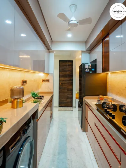 This angle shows the seamless integration of the washing machine and refrigerator at the end of the kitchen line.