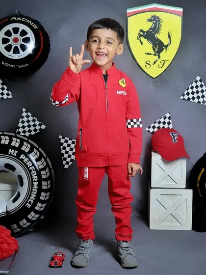 This five-year-old is rocking his Ferrari racing suit. Themed shoots for older kids are a great way to celebrate their hobbies and interests.
