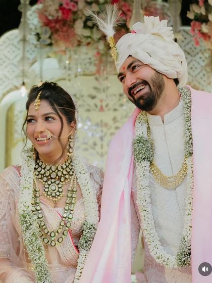 A close up of the bride's happy face. The soft, face framing pieces of her hairstyle add to the romantic feel of the moment.