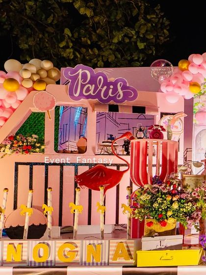 A close-up of the "Paris" sign and a pink flamingo prop, adding a quirky touch to the theme.