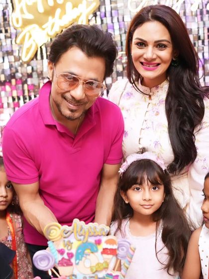 The happy family, Anupam Mittal and Anchal Kumar, with their daughter Alyssa and her vibrant 6th birthday cake.
