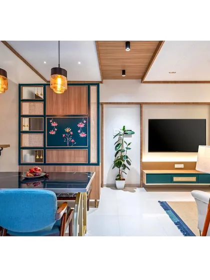 A view from the dining area towards the living room, showing the open-plan layout. The custom floral-painted partition adds an artistic and personal touch.