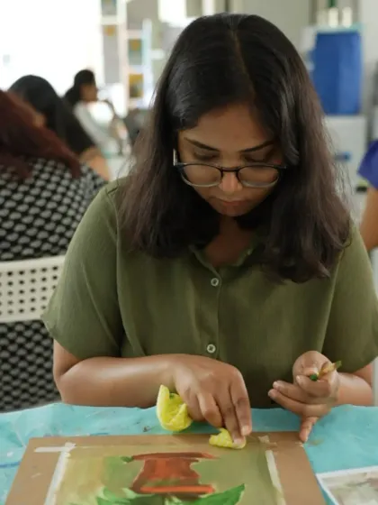 A student uses a sponge to create texture in her acrylic painting, one of the many techniques we teach.