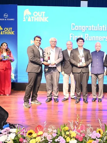 On stage during the awards presentation at the L&T OutThink competition, celebrating with the winners and top management.
