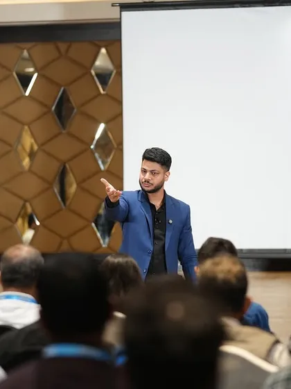 Addressing the audience during a corporate show. My performance style is a mix of stand-up comedy and psychological illusion, keeping the energy high and the audience captivated.