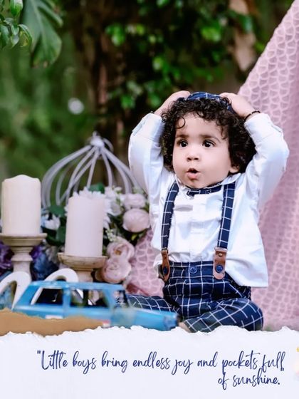 Little boys bring endless joy. This adorable first birthday portrait captures a moment of surprise and wonder in a charming outdoor setup.