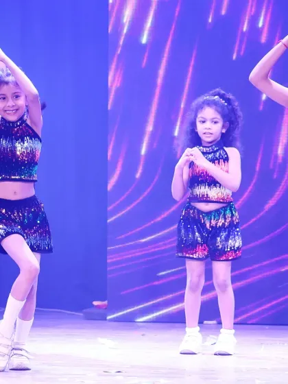 Making heart shapes with their hands, these young dancers share a sweet moment on stage. This performance is from our 'ONSTAGE 25' showcase, highlighting teamwork and friendship.