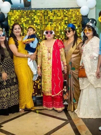 The fun isn't just for kids. Here's a whole family getting into the spirit with silly wigs and glasses in front of a shimmery photo backdrop.
