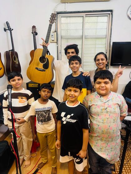 A group photo of our young performers and their coach after a successful "Musical Saturday." It's all about community, fun, and a shared love for music.