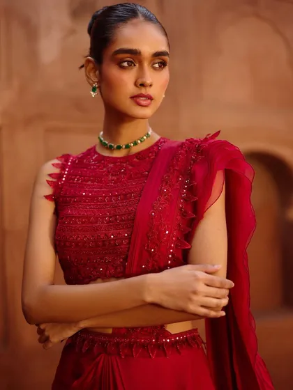 A close-up of a modern red ensemble from the Awigna shoot. The ruffled saree-drape and sequined blouse are perfect for a cocktail party.