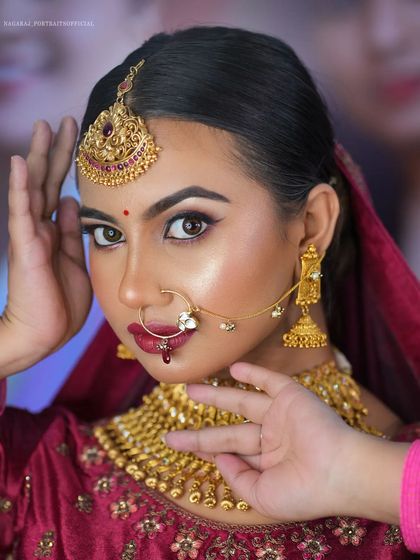 A close-up from a masterclass, demonstrating a North Indian bridal look. The focus is on creating a flawless, glowing base and defining the eyes with kohl and a sharp wing.