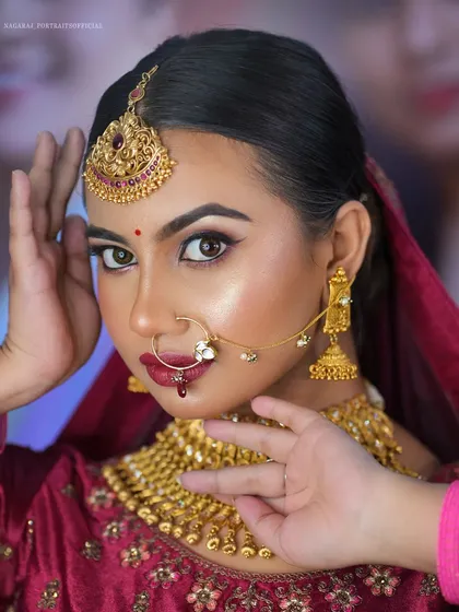 A close-up from a masterclass, demonstrating a North Indian bridal look with a deep maroon lehenga.