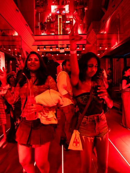 A shot of the crowd vibing under the red lights at a 'Get Salty' party. It was an unforgettable night of great music and energy.