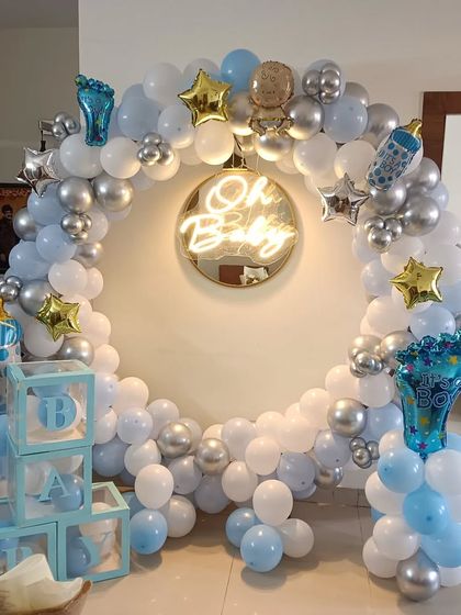This is the full view of my popular 'Oh Baby' welcome home setup. It includes the circular balloon arch, neon sign, 'BABY' blocks, and themed foil balloons, creating a perfect photo corner in your living room.
