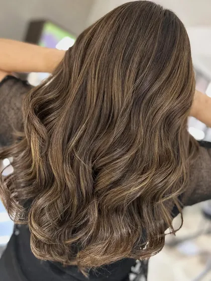 The back view of the warm-to-cool transformation, showing the beautiful dimension and shine of her new color.