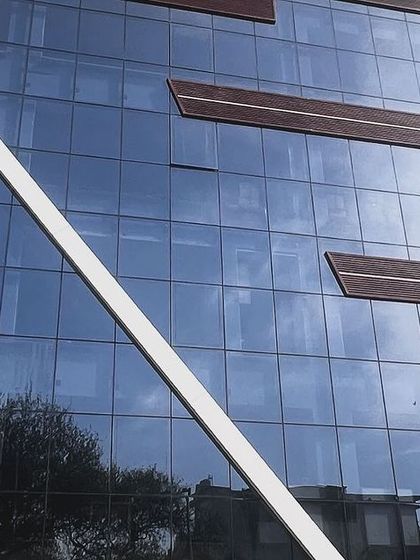 The modern glass facade of the Agni Devices building in Vikas Puri. We are proud to partner with forward thinking companies like this to implement green energy solutions.