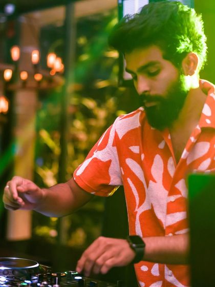 Another angle of me mixing at Raahi, with the green club lights creating a cool effect.