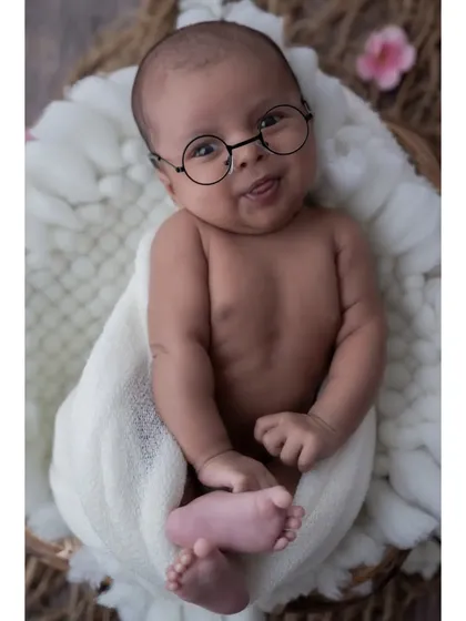 A touch of whimsy can create such a fun and memorable portrait. These tiny round glasses add a playful and studious charm to this little one's expressive face.