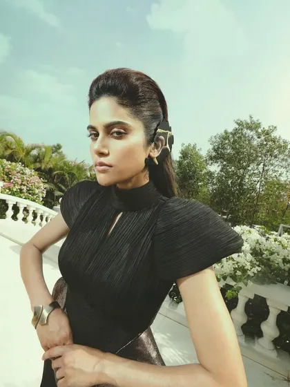 Elegance with an edge. This high-fashion look for Aaditi Pohankar features a dramatic, sculpted hairstyle and sharp, defined makeup that creates a striking and powerful silhouette.