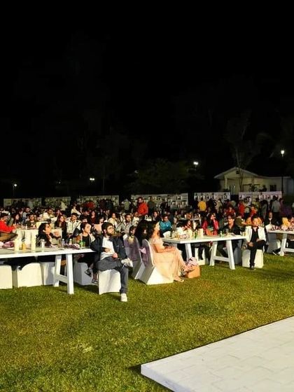 The crowd enjoying the show at the New Year's Gala. Even in a large, open-air setting, I know how to engage the audience and keep them entertained.