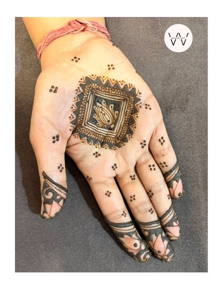 A single-hand view of the minimalist square mandala, perfect for someone who wants a subtle festive touch.